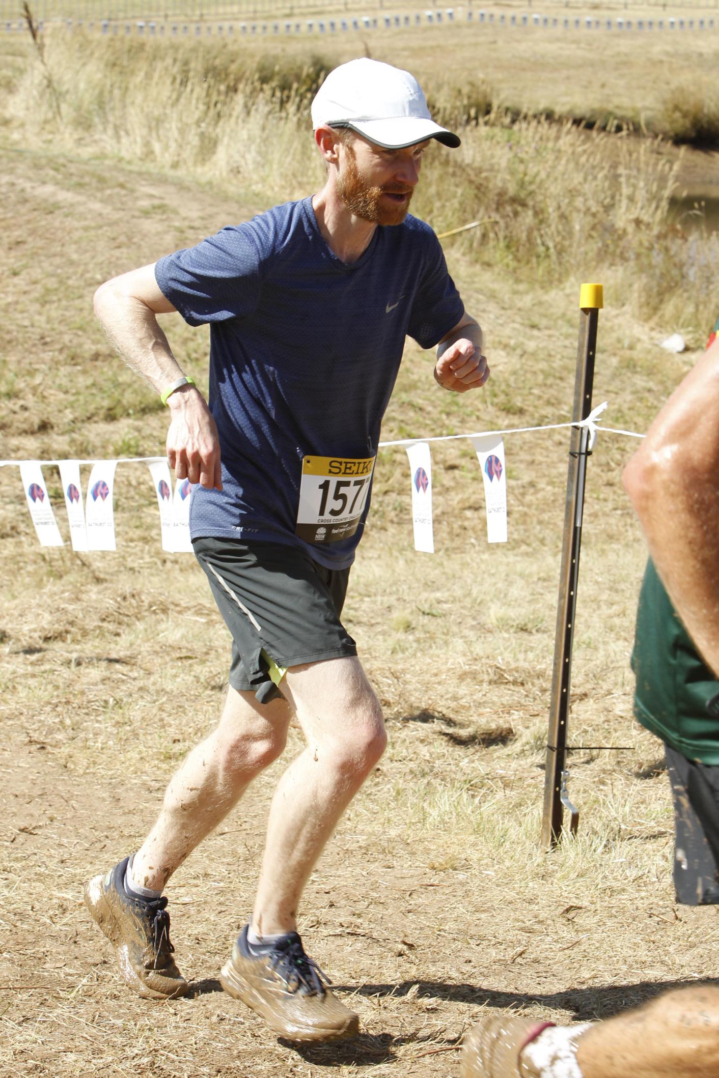 Person running up a dirt hill.